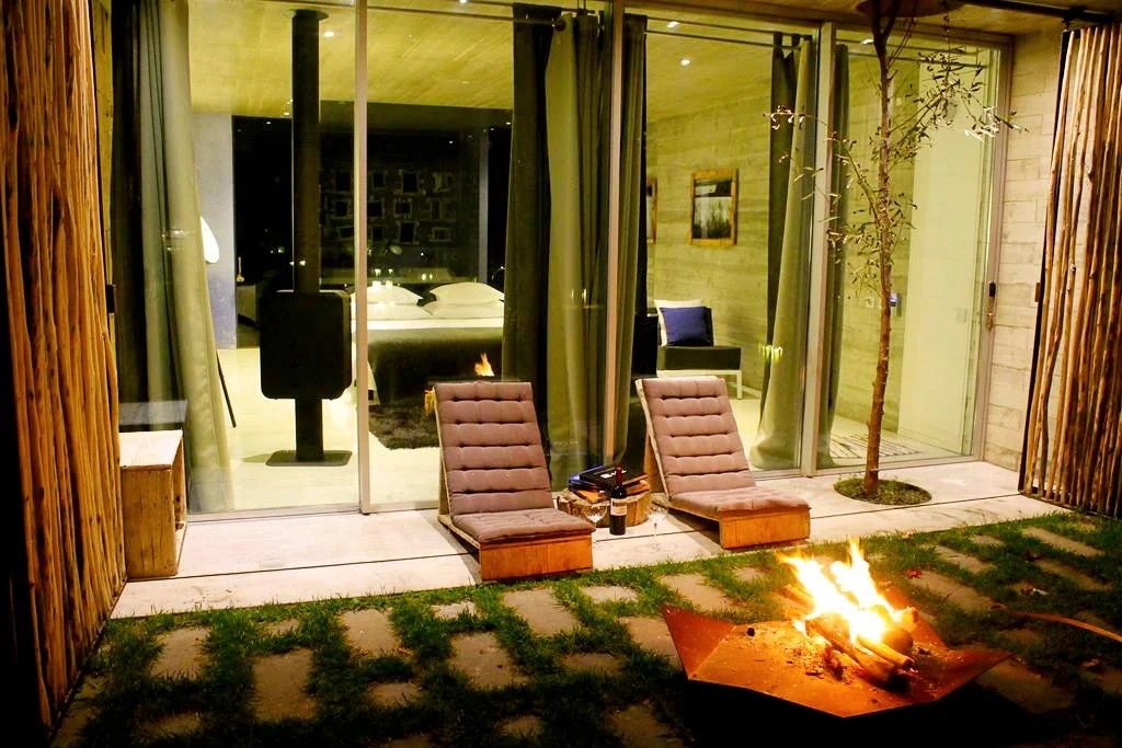 Bedroom terrace with an outdoor fireplace at Rio do Prado hotel