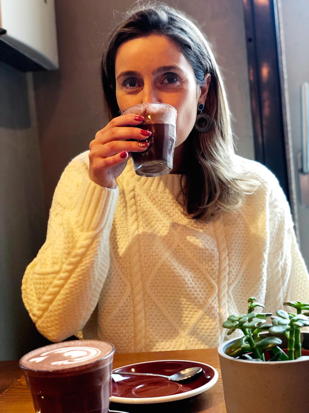 Sara drinking hot chocolate at Zenith, in Porto.