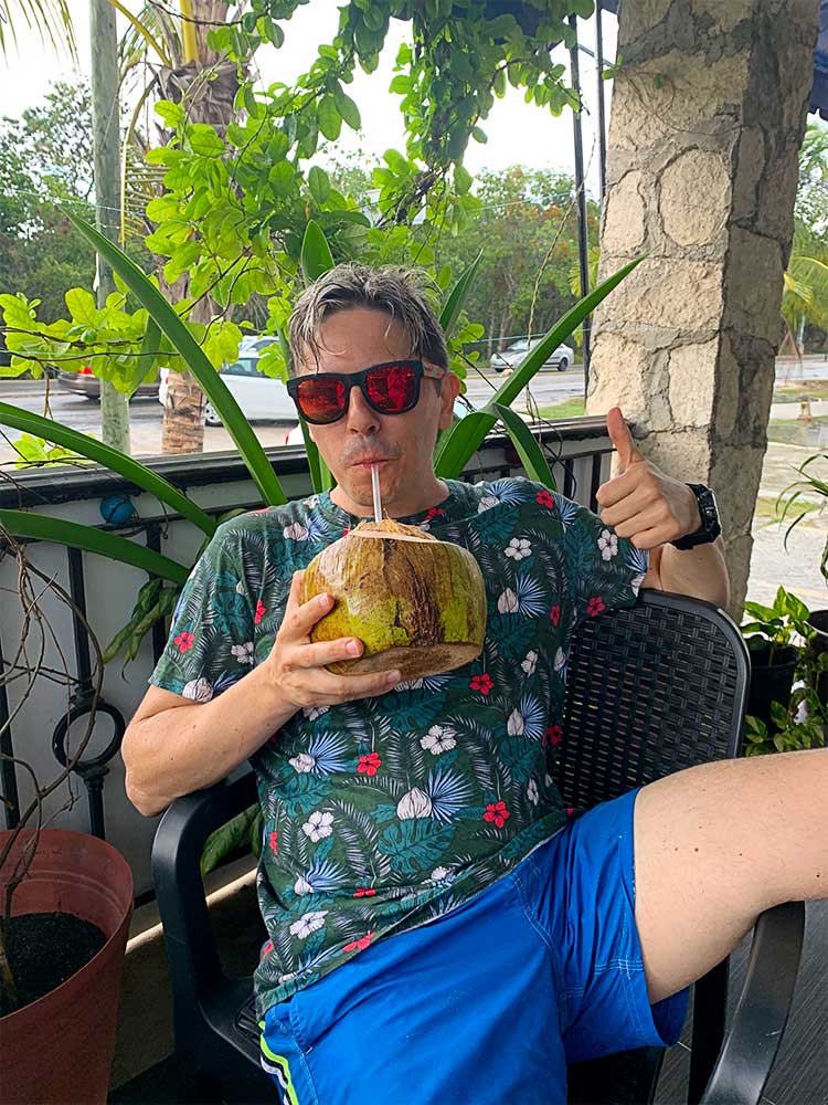 Pedro drinking coconut water in Tulum, Mexico
