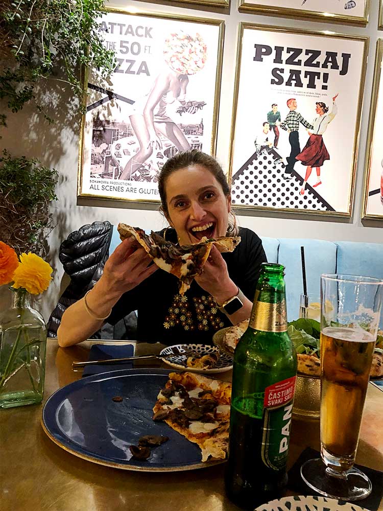 Sara eating pizza at a restaurant in Split, Croatia