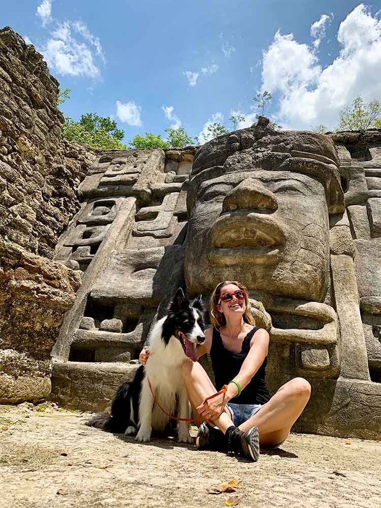 Sara and Rafa sitting on the ground in the ruins of Lamanai.