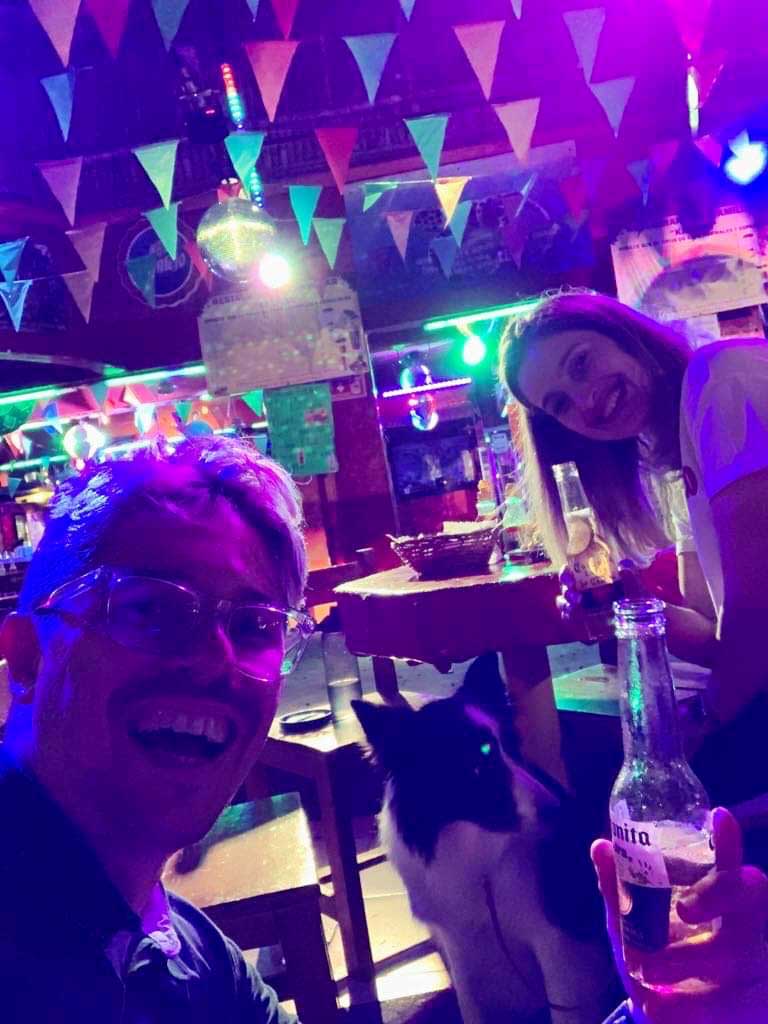Pedro, Sara and Rafa drinking a Corona in a bar in Tulum.