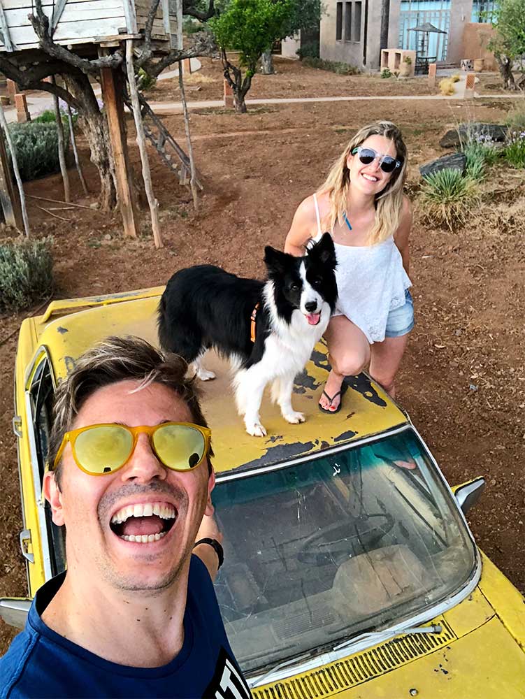 Pedro, Rafa and Sara on top of a yellow car, outside the Hotel Fellah in Marrakech