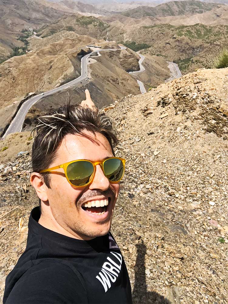 Pedro pointing at the curvy road in the Atlas Mountains in Morocco.