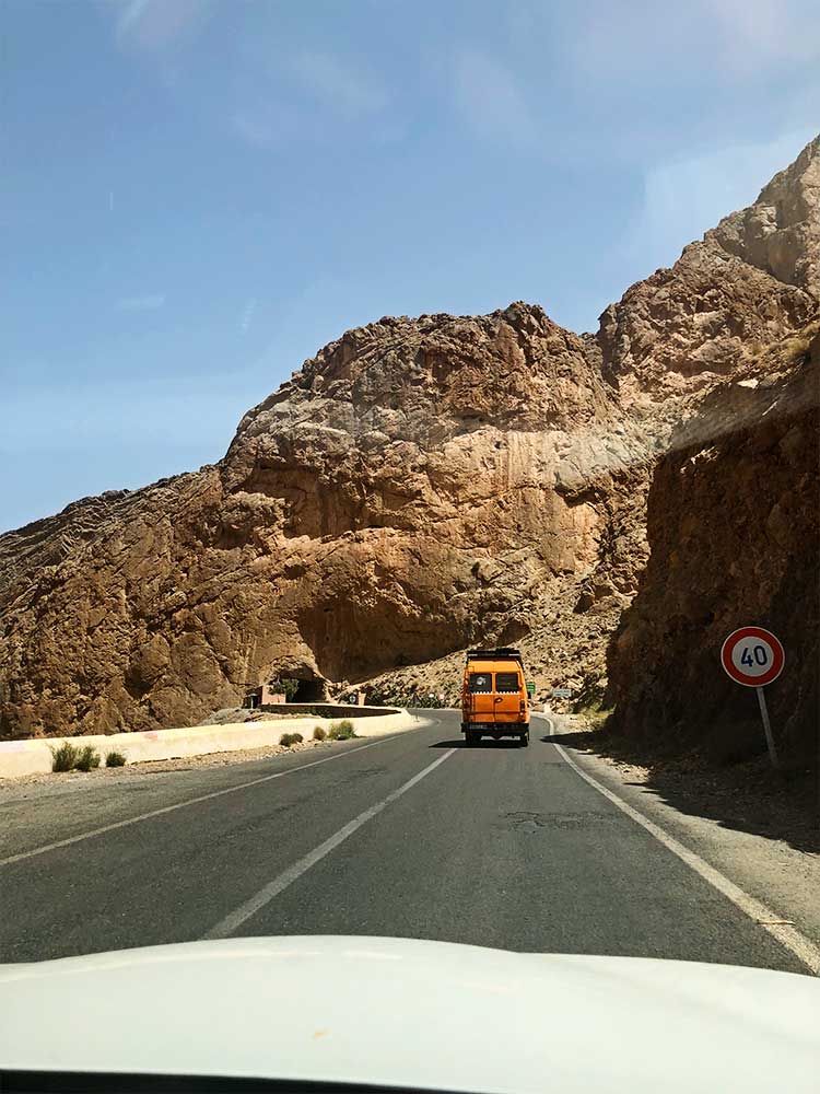 Van driving on a road along the Atlas Mountains in Morocco.