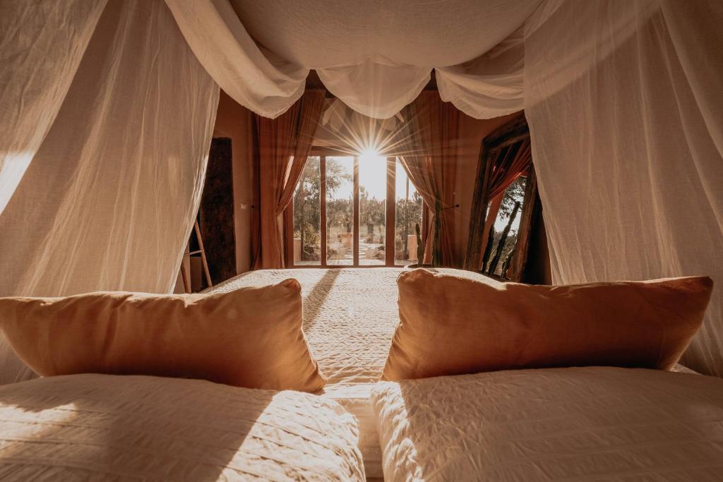Quarto estilo cabana no The Lemon Lodge, com o sol a irradiar sobre a cama de casal.